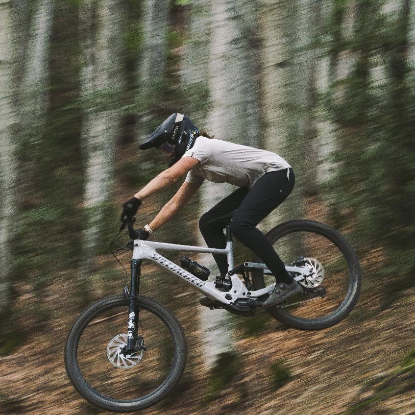 Eine Person springt mit Specialized Kenevo SL e-MTB im Wald