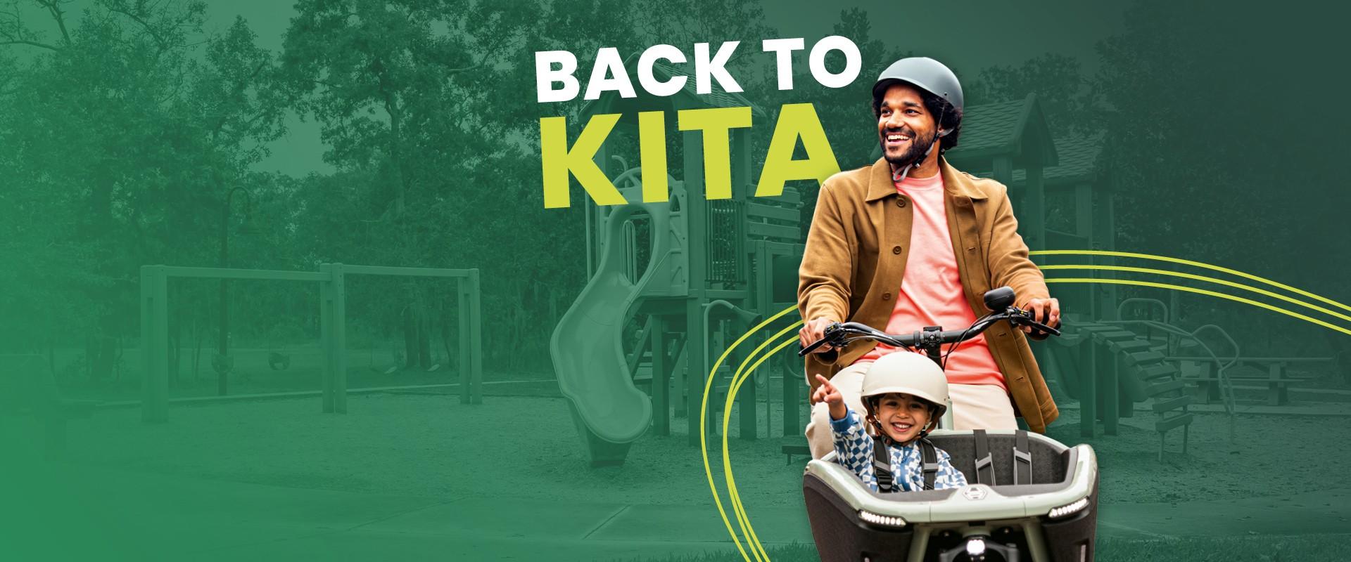Ein Mann fährt auf dem Lasten e-Bike mit seinem Kind mit Helm in der Transportbox
