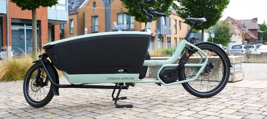 Das Bild zeigt das Urban Arrow Family Next, ein innovatives Lasten-E-Bike, das für urbane Mobilität konzipiert ist.