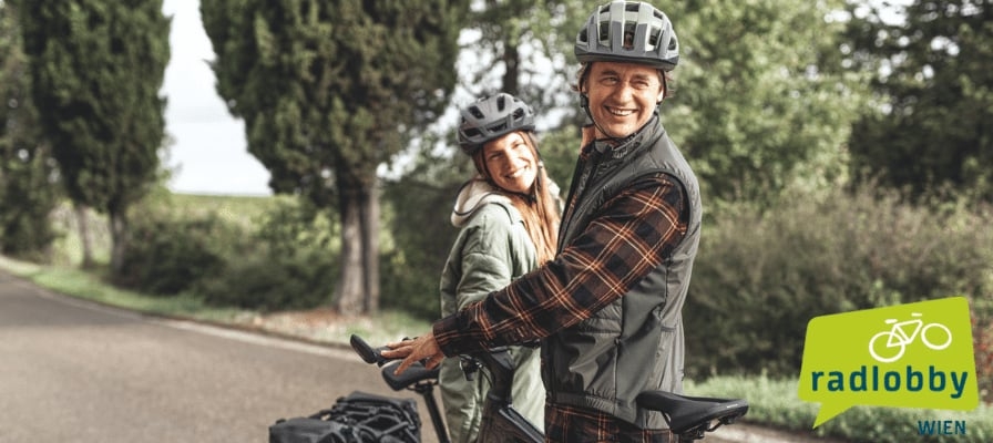 Zwei Personen mit Fahrrädern auf einer Landstraße, Radlobby Wien Logo